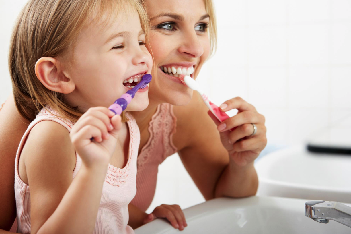 mom-and-daughter-brushing-teeth